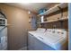 A functional laundry room featuring a washer, a dryer and a water heater at 405 Mcgill Park Ne Ave, Atlanta, GA 30312