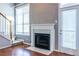 Living room with fireplace, hardwood floors, and access to the outdoors at 405 Mcgill Park Ne Ave, Atlanta, GA 30312
