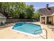 Community pool with ample lounge chairs, trees, and nearby clubhouse for relaxation at 405 Mcgill Park Ne Ave, Atlanta, GA 30312