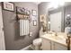 Cozy bathroom features a decorative mirror, open storage, and a sink with vanity at 5607 Stonington Trace Pkwy, Stone Mountain, GA 30087