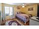 Bedroom with hardwood floors, vintage style area rug and artwork at 5607 Stonington Trace Pkwy, Stone Mountain, GA 30087