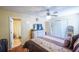 Bedroom features a ceiling fan, TV, dresser, and a bathroom through an open doorway at 5607 Stonington Trace Pkwy, Stone Mountain, GA 30087