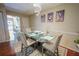 Contemporary dining room with glass table, overhead lighting, and decorative wall art at 5607 Stonington Trace Pkwy, Stone Mountain, GA 30087