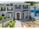 Charming townhome featuring a well-manicured front yard and traditional architectural details at 5607 Stonington Trace Pkwy, Stone Mountain, GA 30087