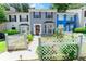 Charming townhouse with landscaped front yard, picket fence, and colorful facade at 5607 Stonington Trace Pkwy, Stone Mountain, GA 30087