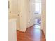 Bright hallway featuring wood floors, an enclosed closet, and natural light coming through the window at 5607 Stonington Trace Pkwy, Stone Mountain, GA 30087