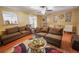 Comfortable living room with ceiling fan, hardwood floors, and ample seating at 5607 Stonington Trace Pkwy, Stone Mountain, GA 30087