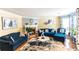 Cozy living room featuring hardwood floors, fireplace, comfortable blue sofas, and neutral wall colors at 5607 Stonington Trace Pkwy, Stone Mountain, GA 30087