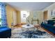 Cozy living room featuring hardwood floors, blue sofa, and neutral wall colors at 5607 Stonington Trace Pkwy, Stone Mountain, GA 30087