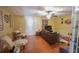 Bright living room with hardwood flooring, a ceiling fan, and comfortable seating at 5607 Stonington Trace Pkwy, Stone Mountain, GA 30087