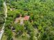 Drone image showcases a home surrounded by lush trees, featuring a prominent red roof and a serene, wooded setting at 751 Upper Burris Rd, Canton, GA 30114