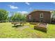 Backyard featuring raised garden beds and picnic area with mature trees at 751 Upper Burris Rd, Canton, GA 30114