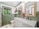 Well-lit bathroom features a double vanity, stylish mirrors, and a window offering a refreshing view of nature at 751 Upper Burris Rd, Canton, GA 30114