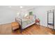 Bright bedroom with light hardwood floors, large windows, and a metal bed frame at 751 Upper Burris Rd, Canton, GA 30114