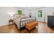 Bright bedroom with light hardwood floors, large windows, and a metal bed frame at 751 Upper Burris Rd, Canton, GA 30114