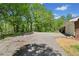Wide driveway with a basketball hoop and a view of the surrounding trees at 751 Upper Burris Rd, Canton, GA 30114