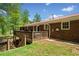 Exterior view of a home with a deck overlooking a lush lawn at 751 Upper Burris Rd, Canton, GA 30114