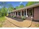 Charming brick home features a welcoming front porch and well-manicured landscaping at 751 Upper Burris Rd, Canton, GA 30114