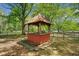 Charming wooden gazebo in a lush yard offers a tranquil retreat surrounded by trees at 751 Upper Burris Rd, Canton, GA 30114