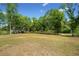 Lush green land with scattered trees offers plenty of space and scenic views at 751 Upper Burris Rd, Canton, GA 30114