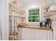 Charming pantry with open shelving, wooden countertop, natural light, and a serene view of the lush outdoors at 751 Upper Burris Rd, Canton, GA 30114