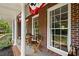 Inviting front porch features brick columns, decorative bunting, and space for outdoor seating at 751 Upper Burris Rd, Canton, GA 30114