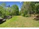 Spacious yard with lush greenery and mature trees creates a tranquil outdoor space at 751 Upper Burris Rd, Canton, GA 30114