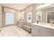 Beautiful bathroom with dual vanities, soaking tub, decorative accents, and window with blind at 1432 Fairmont Ave, Atlanta, GA 30318