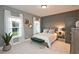 Inviting bedroom with neutral tones, bench seating, complemented by two windows and plant accents at 1432 Fairmont Ave, Atlanta, GA 30318