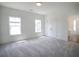 Bedroom featuring two windows, large closet and neutral color carpet at 1432 Fairmont Ave, Atlanta, GA 30318