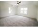 Spacious bedroom features neutral carpet, two windows, and a ceiling fan at 1432 Fairmont Ave, Atlanta, GA 30318