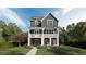 Charming two-story home with a welcoming front porch, detailed trim, and manicured lawn at 1432 Fairmont Ave, Atlanta, GA 30318