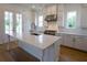 Island kitchen featuring stainless steel appliances, a center island, quartz counters, and hardwood floors at 1432 Fairmont Ave, Atlanta, GA 30318