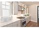 Updated kitchen features white cabinets, stainless steel appliances and modern granite countertops at 1432 Fairmont Ave, Atlanta, GA 30318