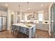 Bright kitchen features a large island with seating, stainless steel appliances, and hardwood flooring at 1432 Fairmont Ave, Atlanta, GA 30318