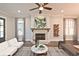 Living room with a brick fireplace, hardwood floors, and lots of natural light at 1432 Fairmont Ave, Atlanta, GA 30318