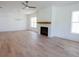 Bright living room featuring a painted fireplace, wood mantle, large windows and ceiling fan at 1432 Fairmont Ave, Atlanta, GA 30318