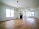 Spacious living room boasts hardwood floors, a modern light fixture and a cozy fireplace at 1432 Fairmont Ave, Atlanta, GA 30318