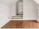 Cozy attic room featuring hardwood floors, crisp white walls, and a charming staircase leading to more space at 1585 S Ponce De Leon Ne Ave # 19, Atlanta, GA 30307