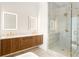 Luxurious bathroom featuring double vanity, illuminated mirrors, and a marble tiled shower with gold accents at 1585 S Ponce De Leon Ne Ave # 19, Atlanta, GA 30307