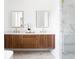 Modern bathroom boasts dual vanities with wood cabinets, quartz countertops, and a glass-enclosed shower at 1585 S Ponce De Leon Ne Ave # 19, Atlanta, GA 30307