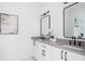 Bright bathroom features double vanity with gray counters, black hardware, framed mirrors, and modern lighting at 1585 S Ponce De Leon Ne Ave # 19, Atlanta, GA 30307