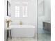 Contemporary bathroom with a stylish freestanding tub, marble tile floor, and a sunlit window at 1585 S Ponce De Leon Ne Ave # 19, Atlanta, GA 30307