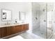 Bright bathroom showcases dual vanities, a glass-enclosed shower with marble tiles and gold hardware at 1585 S Ponce De Leon Ne Ave # 19, Atlanta, GA 30307