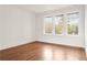 Sunlit bedroom featuring hardwood floors, crisp white walls, and windows with a view of mature trees at 1585 S Ponce De Leon Ne Ave # 19, Atlanta, GA 30307