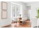 Charming dining area with a round table, modern chairs, and bench seating, bathed in natural light from large windows at 1585 S Ponce De Leon Ne Ave # 19, Atlanta, GA 30307