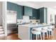 Spacious kitchen featuring teal cabinets, stainless steel appliances, a large center island, and ample counter space at 1585 S Ponce De Leon Ne Ave # 19, Atlanta, GA 30307