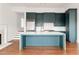 Open kitchen with an island, stainless steel appliances, and dark teal cabinets at 1585 S Ponce De Leon Ne Ave # 19, Atlanta, GA 30307