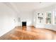 Spacious living room with hardwood floors, fireplace, and bright bay windows at 1585 S Ponce De Leon Ne Ave # 19, Atlanta, GA 30307