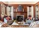 Elegant living room features detailed woodwork, fireplace, mantle, matching chairs, and decorative throw pillows at 1585 S Ponce De Leon Ne Ave # 19, Atlanta, GA 30307